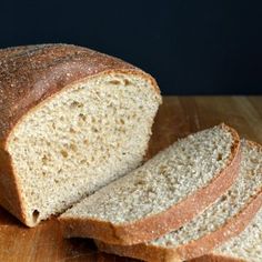 a loaf of bread sitting on top of a wooden cutting board