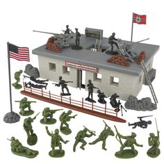 toy soldiers are standing in front of a building with an american flag on the roof