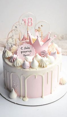 a birthday cake decorated with pink and white icing