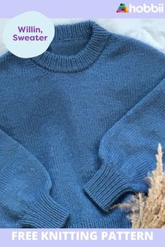 a blue sweater sitting on top of a bed next to a pile of dry grass