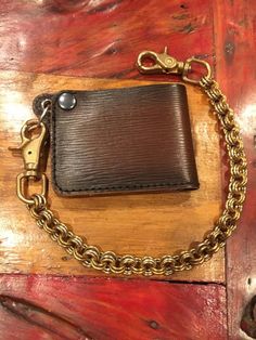 a leather wallet with a chain attached to it