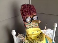 a cake made to look like a scarecrow with glasses on it's head