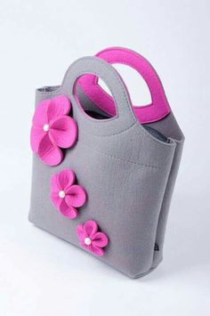 a gray bag with pink flowers on the front and side, sitting against a white background