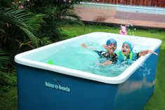 two people are playing in an outdoor swimming pool