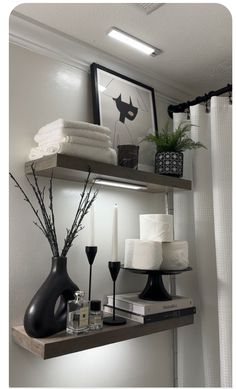 a shelf with towels, candles and vases on it