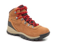 a pair of brown hiking boots with red laces on the outstretches