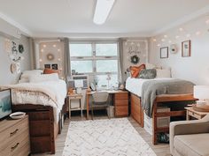 a bedroom with two beds and a desk