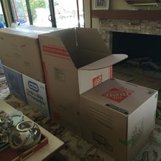 two boxes stacked on top of each other in front of a fire place with windows