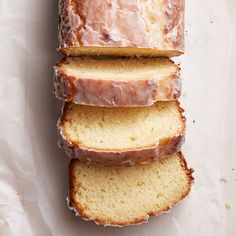 a loaf of lemon pound cake sitting on top of a piece of waxed paper