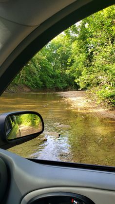 the view from inside a car looking at a river