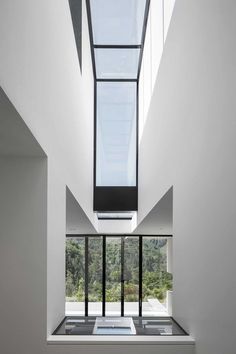 the interior of a modern house with large windows and skylights on the roof area