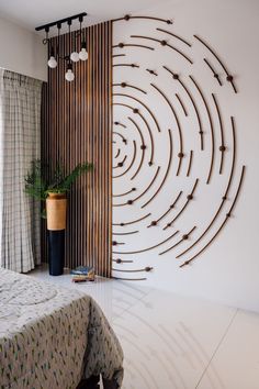 a bed room with a neatly made bed and a large wall decoration on the wall