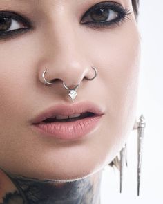 a woman with piercings on her nose