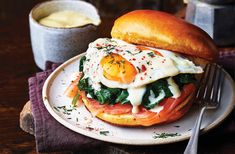 a sandwich with eggs and spinach is on a plate