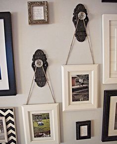 a bunch of pictures hanging on the wall next to each other with frames attached to them