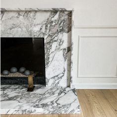 a white marble fireplace in a living room