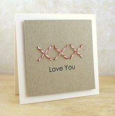 a card with two pins attached to it that says love you