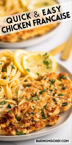 two white plates topped with chicken and pasta next to lemon wedges on a table