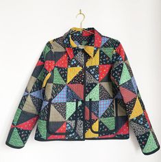 a colorful jacket hanging on a white wall