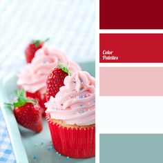 cupcakes with pink frosting and strawberries on a blue checkered tablecloth