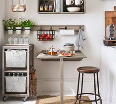 a small kitchen with two shelves above the counter and an open shelf on the wall