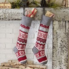 two christmas stockings hanging from a fireplace mantel