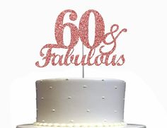 a white cake topped with a red glitter 60 and fabulous birthday cake topper