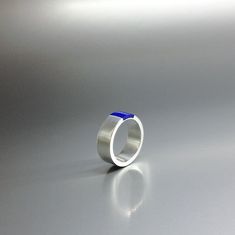 "Modern band ring Lapis Lazuli and Sterling silver inlay. Unique gift for her, girlfriend, friend, wife, mom, September and October birthstone, 8 year anniversary. Beautiful ring with a design of simplicity and modern elegance. The stone is set in the middle of the Sterling silver band. This beautiful ring is worked with the technique of inlay, which means the stone is worked seamlessly into the Sterling silver. All our stones are natural stones and our jewelry is handmade, slight differences in Blue Sterling Silver Round Band Jewelry, Modern Blue Gemstone Jewelry, Modern Sterling Silver Blue Ring, Blue Sterling Silver Ring With Polished Finish, Blue Sterling Silver Rings With Polished Finish, Modern Blue Sterling Silver Ring, Blue Round Band Jewelry Gift, Modern Blue Sapphire Ring Hallmarked, Minimalist Blue Sapphire Ring For Anniversary