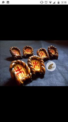 five pieces of gold metal with red crosses on them