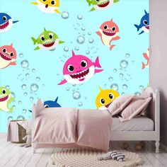 a room with a bed and wallpaper that has different types of sharks on it