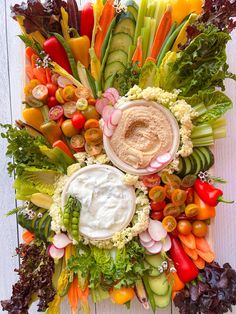 an assortment of vegetables and dip in a bowl