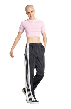 Signature 3-Stripes make a sporty statement at the tear-away sides of old-school track pants made from recycled polyester. Elastic waist Side-seam pockets 100% recycled polyester Machine wash, dry flat Imported Sporty Spring Activewear With Side Stripes, Adidas Sporty Relaxed Fit Joggers, Sporty Adidas Moisture-wicking Sweatpants, Adidas Sporty Moisture-wicking Sweatpants, Adidas Sporty Sweatpants With Moisture-wicking, Adidas Athleisure Activewear In Relaxed Fit, Adidas Relaxed Fit Athleisure Activewear, Sports Bottoms With Side Stripes For Spring, Sporty Sweatpants With Side Stripes For Spring