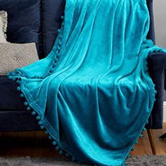 a blue couch with a blanket on top of it