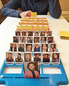 a table topped with lots of pictures and cards on top of blue trays filled with photos