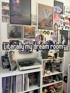 there is a record player on top of a book shelf with many pictures above it