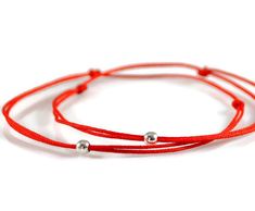 Set of Two Red String Bracelets * Evil Eye Bracelets * Couples Bracelets * Friendship Gift * Wear for protection against the evil eye and negative energy. * It is believed that the left side of the body is the receiving side, so wearing it on the left wrist allows the receiving of good fortune. D E T A I L S ----------------- This listing is for TWO bracelets, they are made of red 0.5mm nylon cord with a tiny 3mm sterling silver bead. C L O S U R E _ O P T I O N S ------------------------------- Red Round Beads Bracelet As Gift, Red Friendship Bracelets With Sliding Knot, Handmade Adjustable Red Wrap Bracelet, Adjustable Red Handmade Wrap Bracelet, Red Bracelet With Sliding Knot For Valentine's Day, Red Round Beads Bracelets For Friendship, Red Sliding Knot Bracelet For Valentine's Day, Adjustable Red Bracelets With Round Beads, Adjustable Red Round Bead Bracelets