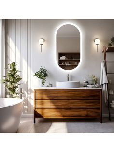 a bathroom with an oval mirror above the sink and a bathtub in front of it