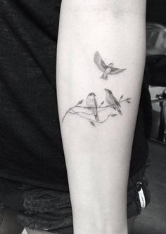 two birds sitting on top of each other with the words tattooblend com above them