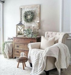 a living room filled with furniture and a white blanket on top of a chair in front of a window