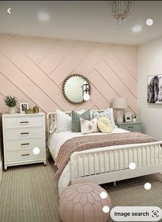 a bedroom decorated in pastel colors with white furniture and pink accent wallpapers