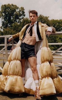 a man sitting on top of a pile of sand bags