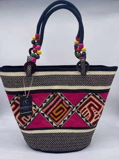 These beautiful handbags are made from Cana Flecha which is an indigenous palm fiber found in the northern territory of Colombia. They are beautifully hand crafted by the people from the Zenu tribes in Colombia. These handbags are colorful with vibrant colors, which is a pure reflection on the region and the warmness of these master artisans that work in this industry every day. Handwoven Palm Leaf Bag For Daily Use, Fair Trade Tote Bag For Vacation, Handwoven Palm Leaf Tote Bag, Fair Trade Palm Leaf Bag For Vacation, Traditional Rectangular Market Bag, Natural Color Fair Trade Bags For Everyday Use, Traditional Handwoven Top Handle Bag, Daily Use Fair Trade Jute Bag, Traditional Straw Tote Bag In Natural Fiber