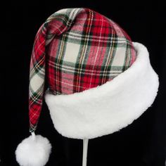 "This festive novel Santa Claus hat is made up in a red multicolor plaid flannel fabric. The fabric is a heavier weight quality cotton flannel shirting fabric, cozy and warm. The hat is accented with snowy white soft Sherpa faux fur fabric trim. Proportions of the hat are generous and will fit most head sizes, ladies or gents. The styling is a traditional Santa slouch stocking style cap. Measurement for opening for your head is 24-25\" circumference and the length is 19\". There is a snowy white Plaid Flannel Fabric, Santa Costume, Holiday Hats, Santa Claus Hat, Shirting Fabric, Fur Fabric, Fur Fabrics, Faux Fur Fabric, Red Tartan