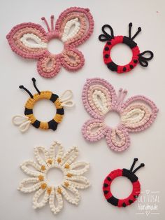 four crocheted butterfly hair clips are shown in different colors and sizes, one is pink, the other is yellow