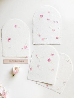 four pieces of paper with pink flowers on them