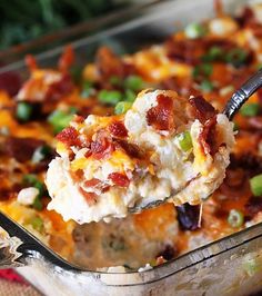 a spoonful of loaded casserole with bacon and green onions