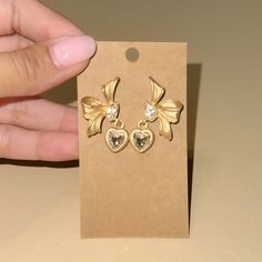 Rhinestone Decor Heart Dangle Vintage Style Bow Stud Earrings In Gold Tone Hardware The Color Is More Like The First Picture New (Boutique Packaging) **Let Me Know If You Like To Bundle With Another Listing! **I Always Accept Reasonable Offers Cute Earrings Cute Jewelry Dainty Jewelry Summer Vacation Cute Outfits Trendy Jewelry Formal Jewelry Wedding Earrings Lovers Gift Holiday Gift Gift For Her Tags : Anthro Anthropologie Free People We The Free Zara Zara Jewelry Lili Pulitzer Kendra Scott 8 O Boutique Packaging, Jewelry Formal, Anthropologie Jewelry Earrings, Formal Jewelry, Zara Jewelry, Geometric Hoop Earrings, Jewelry Summer, Jewelry Dainty, Gold Pearl Earrings