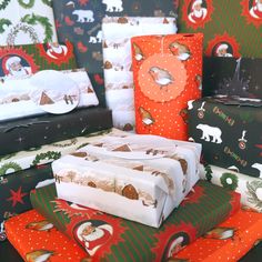 several presents are stacked on top of each other in different colors and patterns, including wrapping paper