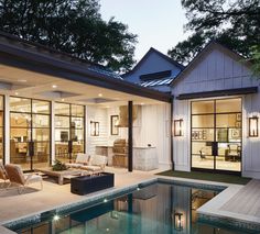 a house with a pool in the middle of it and lots of windows on each side