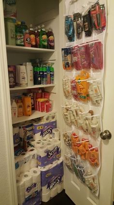 an organized pantry with lots of toilet paper and cleaning products on the door shelfs